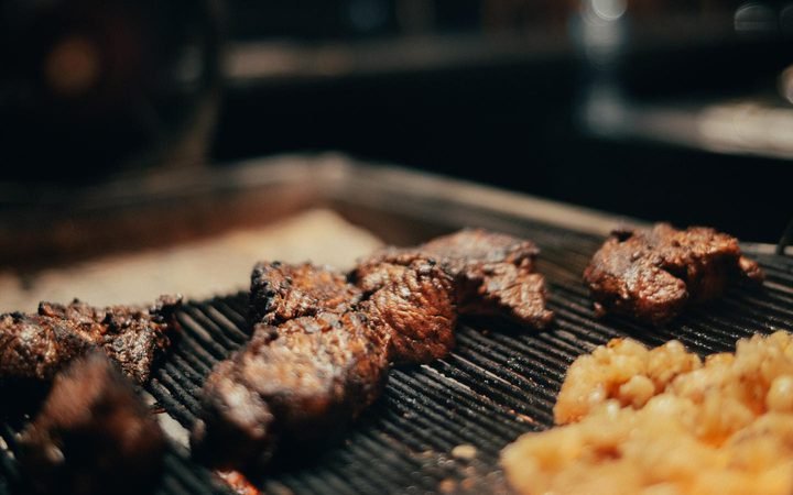 Premium steaks searing on the grill